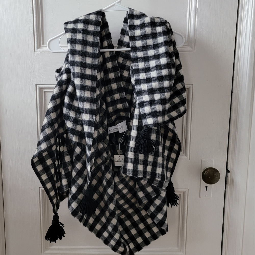 Black and white plaid cape scarf with arm holes.